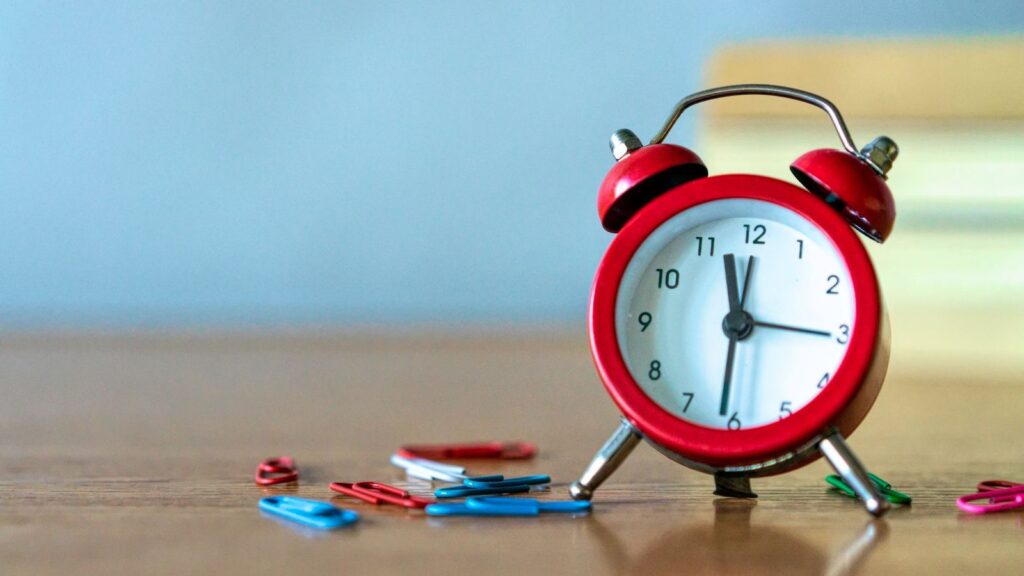 Alarm clock on a wooden desk, a simple way to remember the timed doses after sex