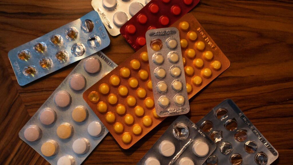 Blister pack of daily tablets next to a calendar, representing a daily PrEP routine