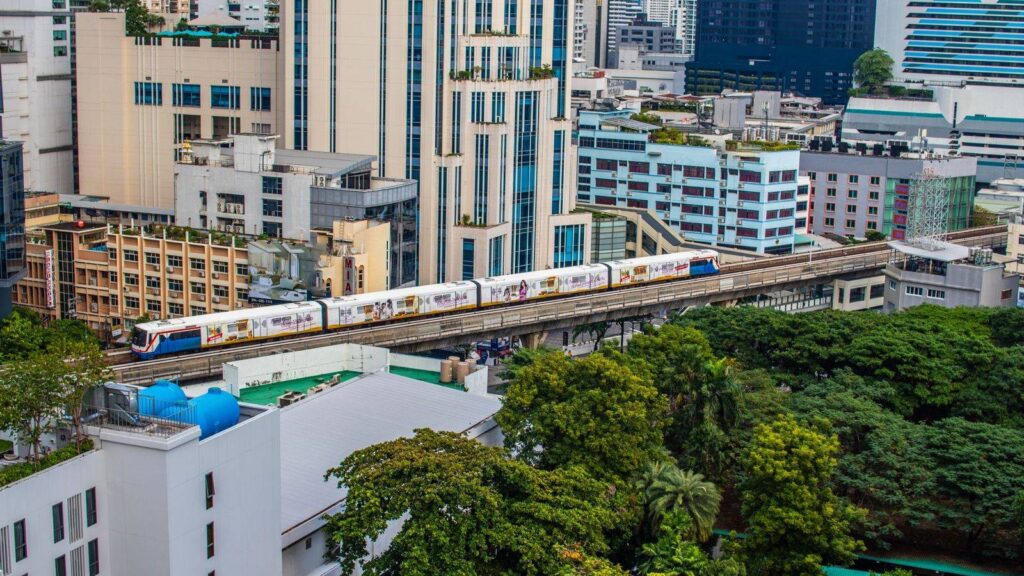 BTS Skytrain passing above Sukhumvit Road in Bangkok, near Asok station