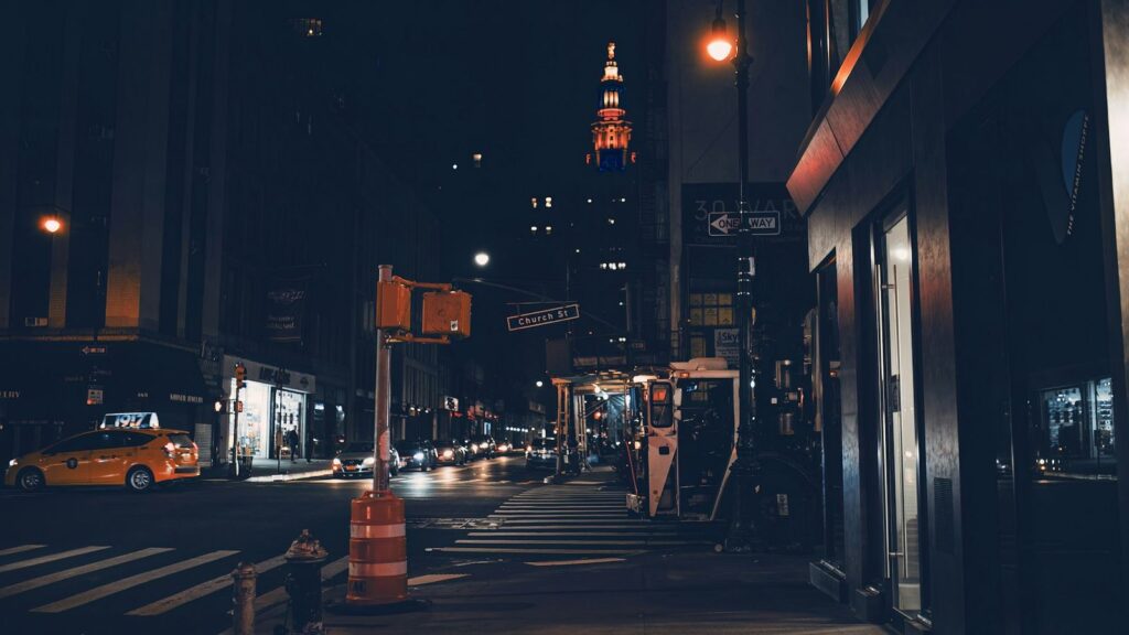 City street at night with taxi lights, the quickest way to reach a hospital after clinic hours
