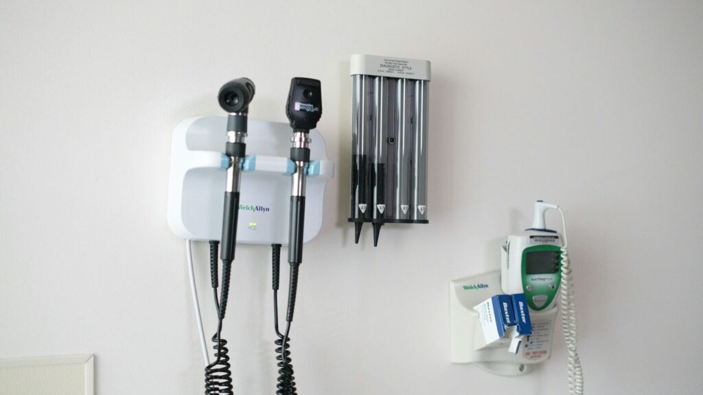 Examination equipment on the wall of a clean, private clinic room
