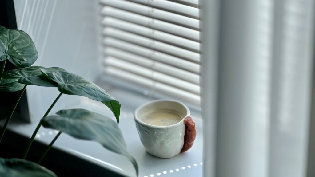Coffee cup on a sunny windowsill, a reminder that a morning dose may help if PrEP affects sleep