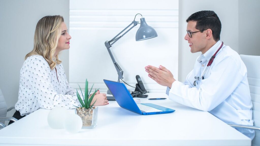 Doctor discussing exposure risk and PEP with a patient in a private consultation room