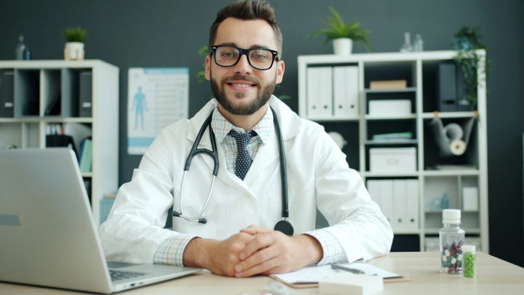 Doctor explaining a prescription to a patient across a clinic desk before starting PEP