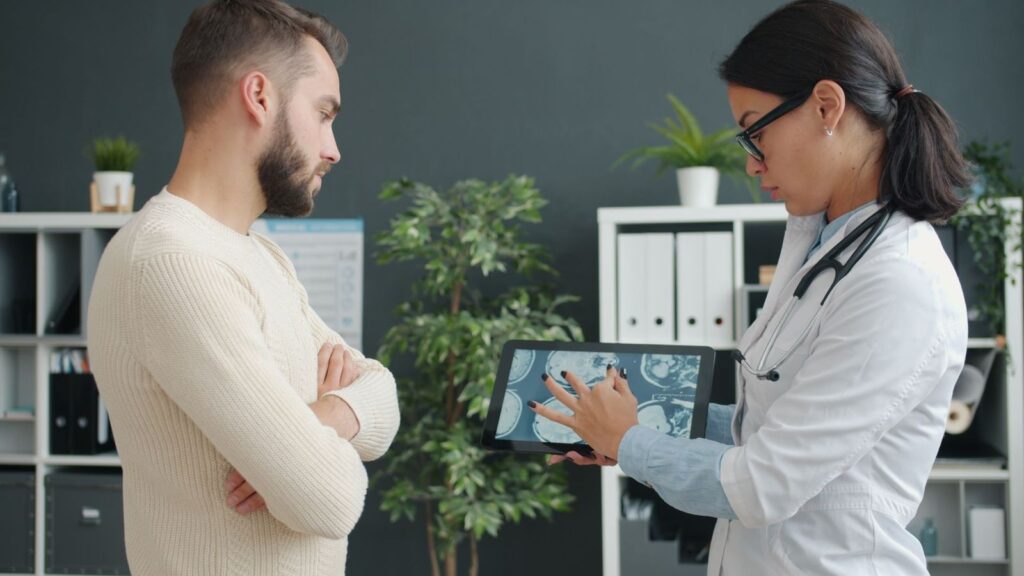 Doctor explaining test results to a patient across a desk