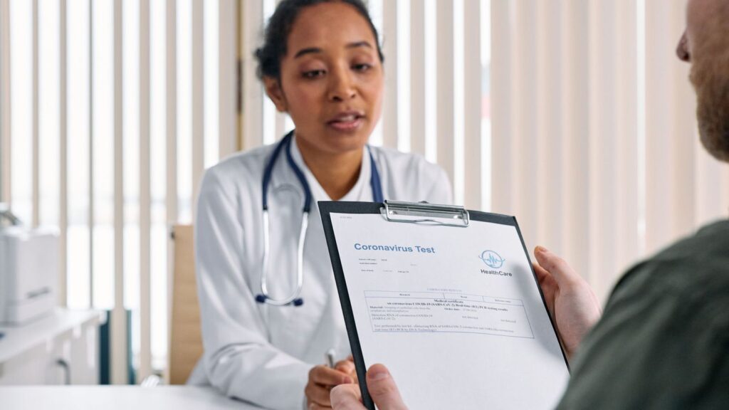 Doctor explaining test results to a patient at a desk after a course of PEP