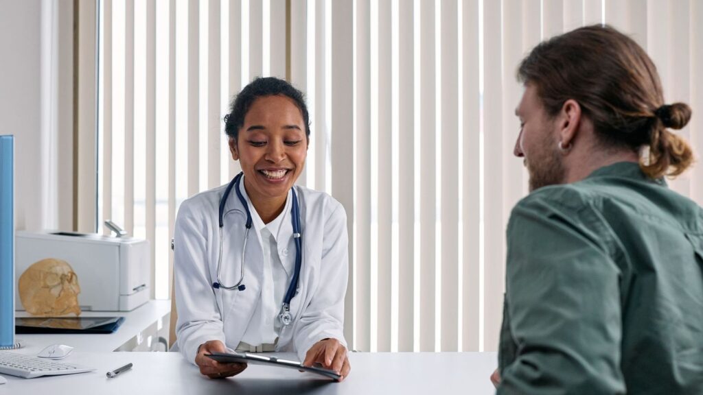 Doctor listening to a patient in a private consultation room while assessing a possible HIV exposure