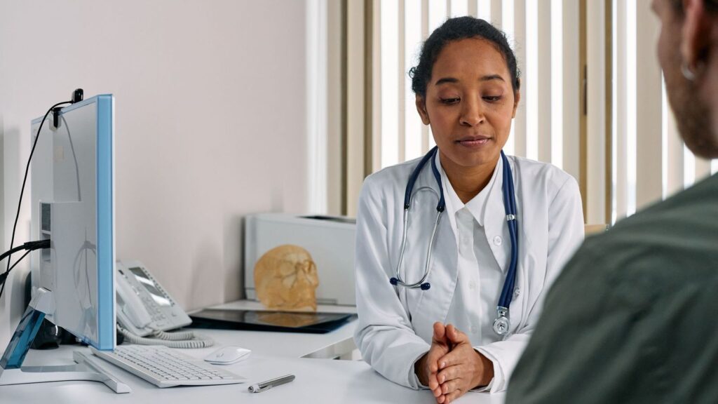 Doctor listening to a patient in a quiet clinic office during an emergency PEP assessment