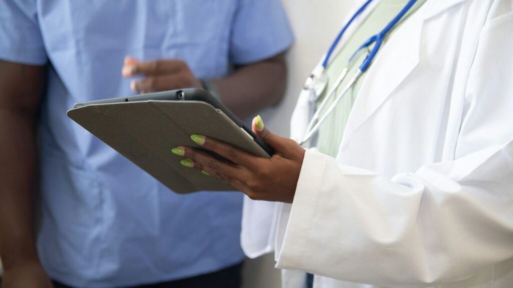 Doctor showing a patient a chart on a tablet to explain HIV risk by type of exposure