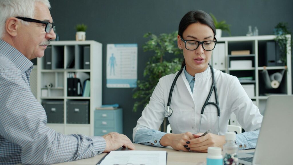 Doctor talking calmly with a patient about HIV test results in a private consultation room