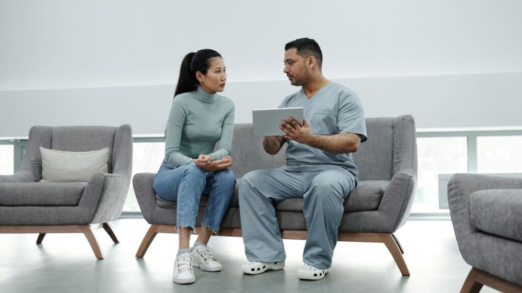 Clinician talking calmly with a patient at the clinic about HIV test results