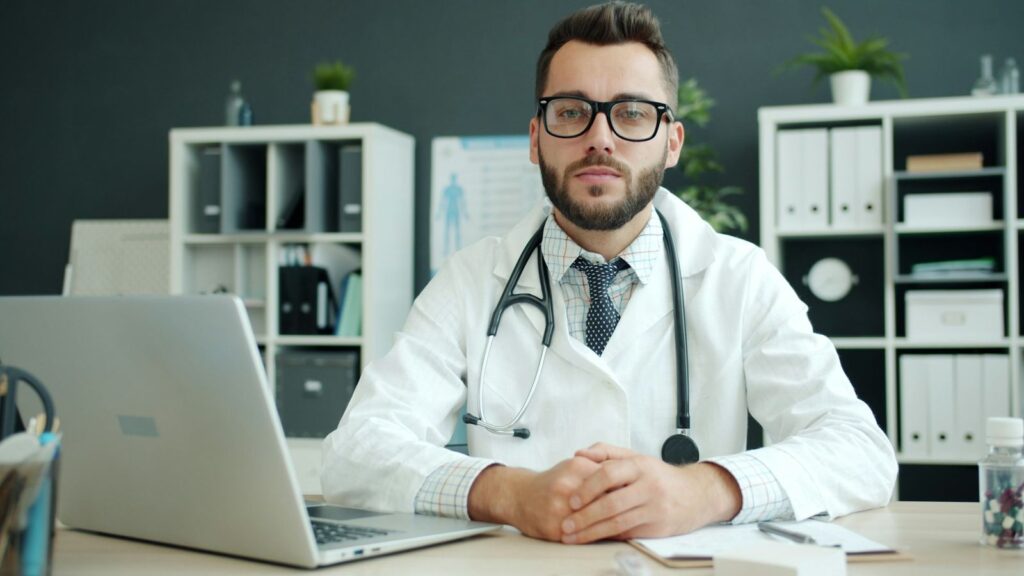 Doctor talking with a patient across a clinic desk about when PrEP starts to protect