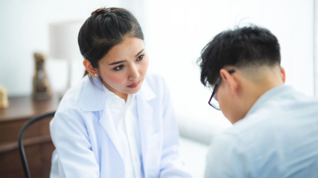 Doctor talking with a patient in a private clinic room during a PrEP check-up