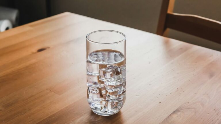 Glass of water next to daily tablets on a table, a simple routine for taking PEP on time