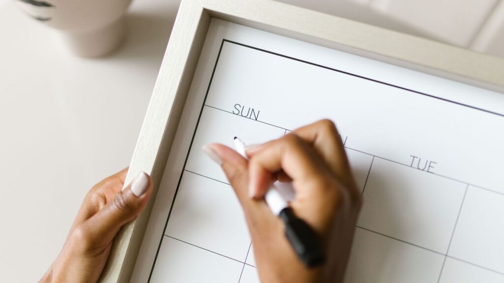 Hand writing plans on a wall calendar, a reminder that on-demand PrEP starts before sex