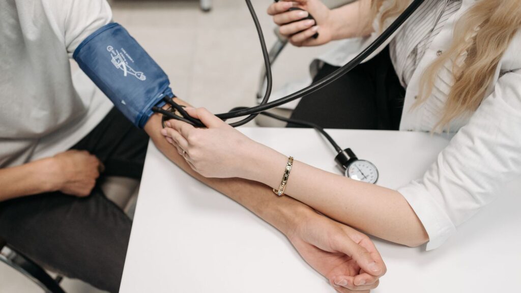 Nurse checking a patient's blood pressure during a routine PrEP check-up