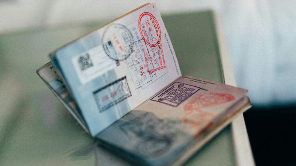 Passport and travel documents on a table, planning PEP dose times while travelling