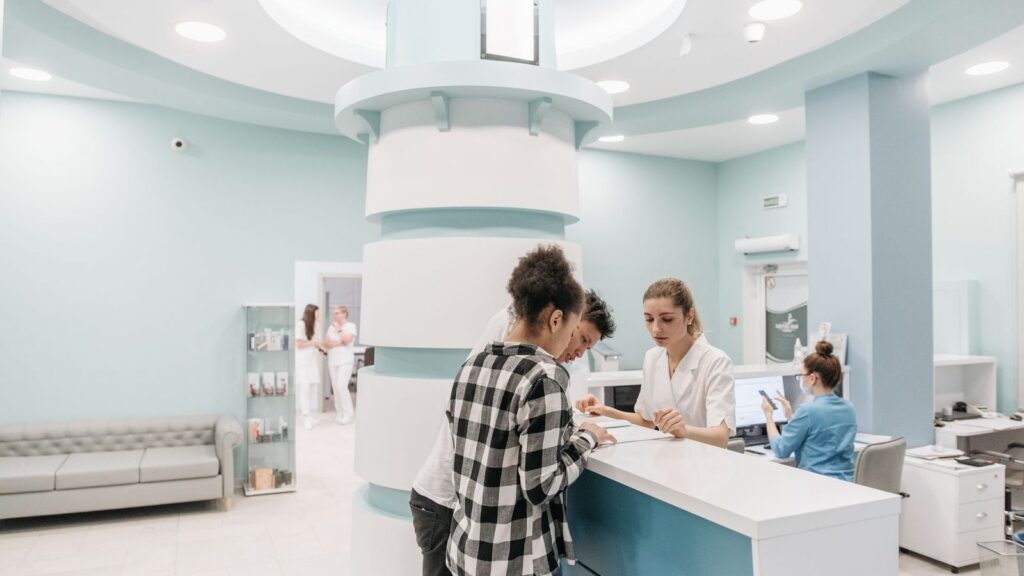 Patient checking in at a clinic front desk for a confidential HIV PrEP appointment