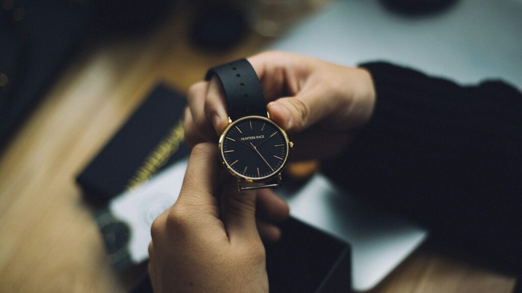 Person checking a wristwatch in the evening, working out how many hours have passed since an exposure