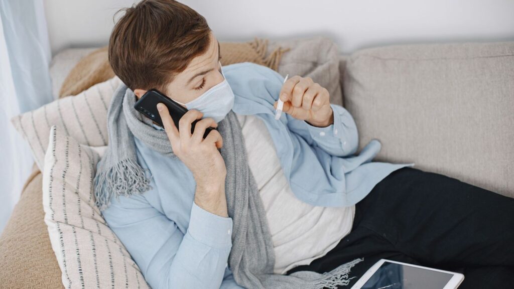 A person at home on a phone call with a clinic, asking a doctor about a side effect during their PEP course