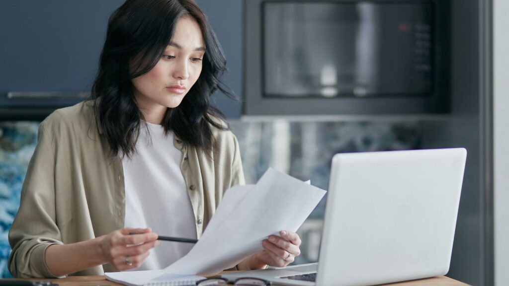 Person reading about symptoms on a laptop in the evening
