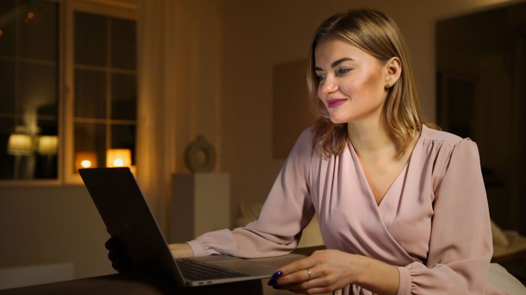 Person reading on a laptop at home in the evening, looking up stories about PEP online