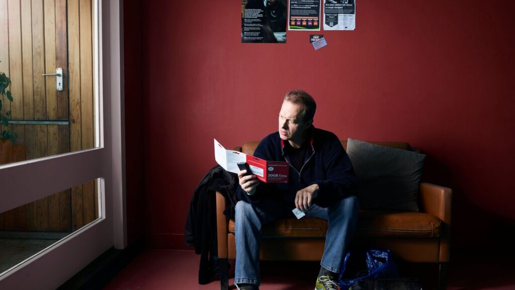 Person reading a medicine leaflet at home to check which PrEP side effects to report