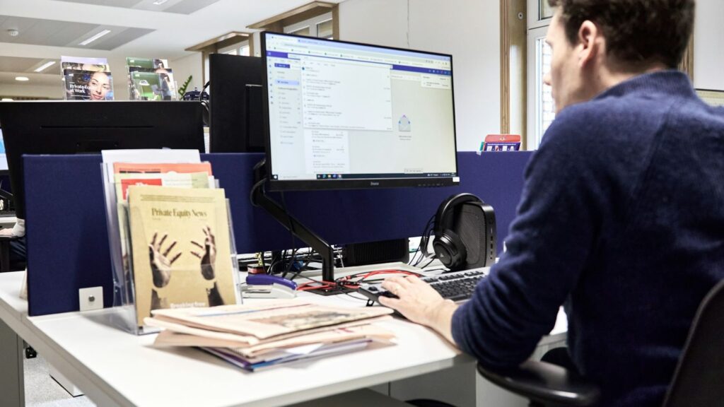Person reading a printed research report at a desk, like the published studies behind U=U