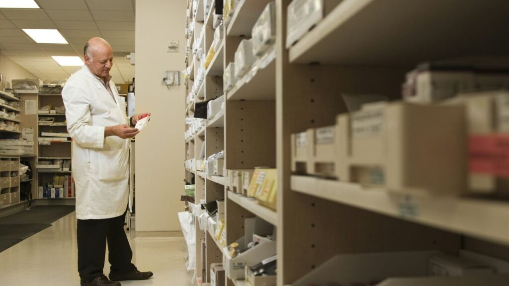 Pharmacist behind a counter, where PEP should not be bought without a medical assessment