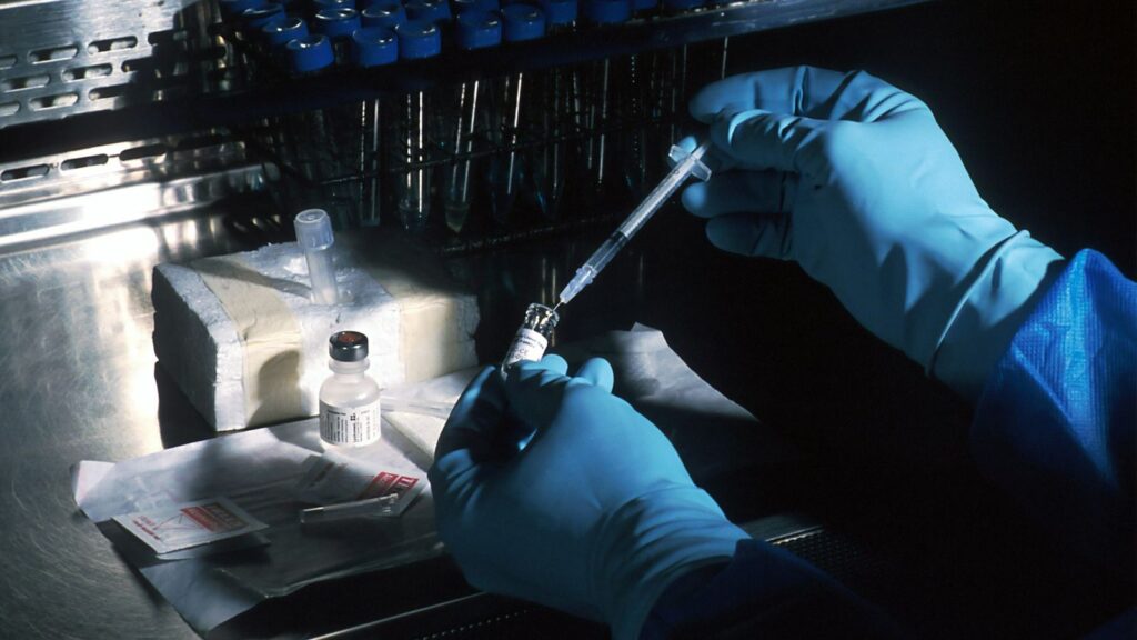 Scientist using a pipette in a laboratory where confirmatory HIV tests are run