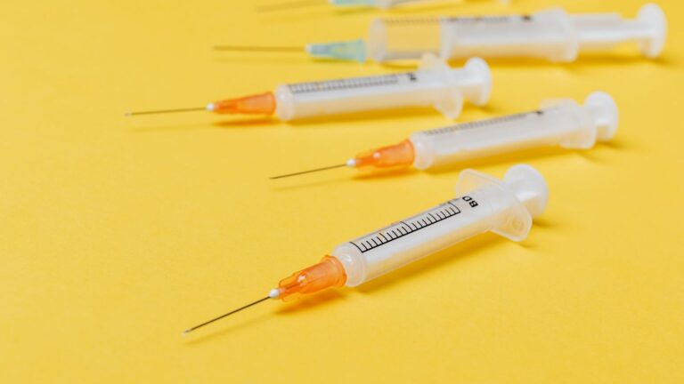 Sharps disposal container in a clinical room, used to prevent needle-stick injuries