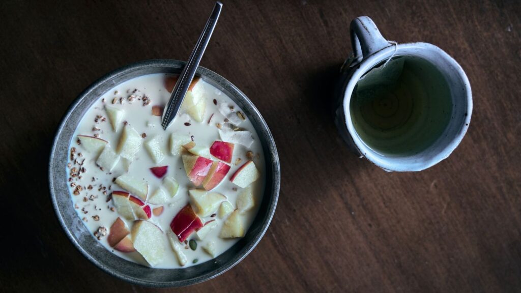 Simple breakfast bowl on a wooden table, as taking PrEP with food can ease nausea