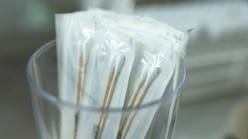 Sterile cotton swabs in sealed packaging, as used for throat and other STI tests