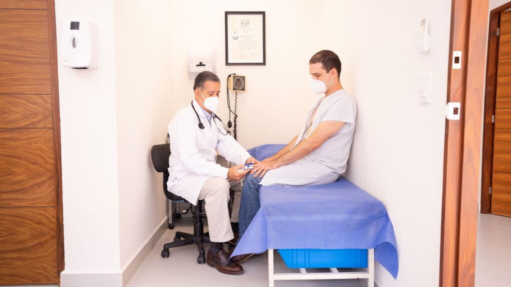 Traveller speaking with a doctor in a quiet, private consultation room