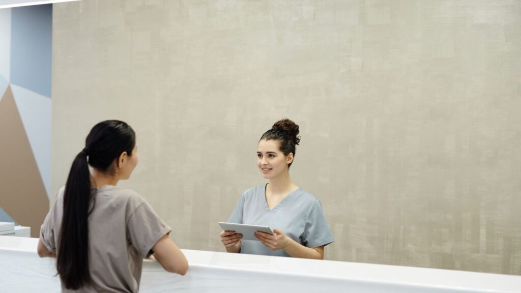 Patient being welcomed at a clinic reception desk for a walk-in PEP visit