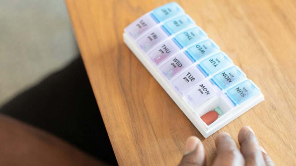 Weekly pill organiser on a table, a simple way to keep daily PrEP doses on track