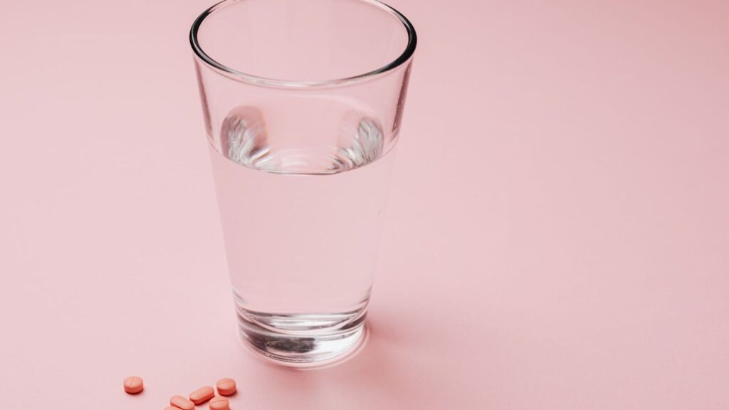 Tablets and a glass of water, ready for a first PEP dose taken at the clinic
